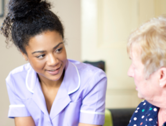 Care worker having a chat with an elderly woman.