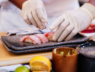 Person preparing food with gloves on