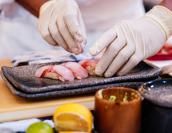 Person preparing food with gloves on